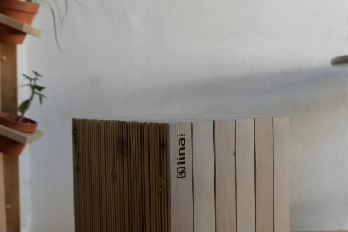 Weiße Wand mit Holzbauelementen von LINA HAUS